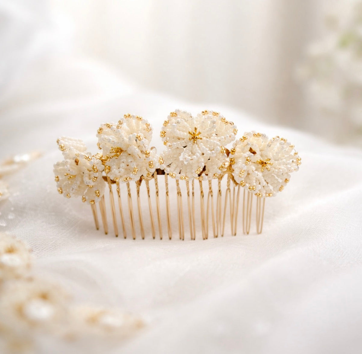 Beatrice bridal hair comb by Vowen, four hand-beaded ivory flowers with gold detailing on ivory silk