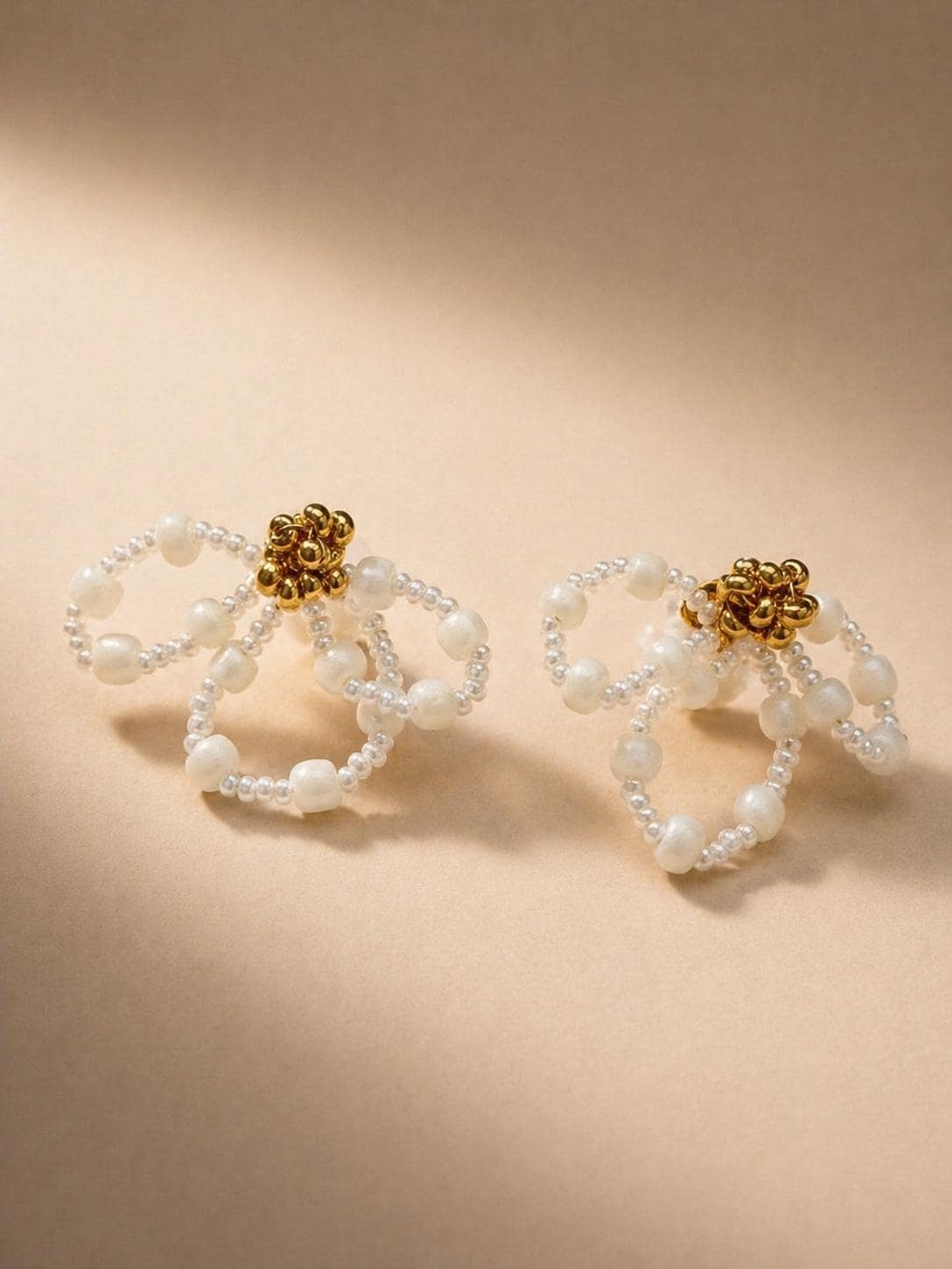 Iris bridal earrings by Vowen, looped ivory beadwork with a gold-tone flower centre