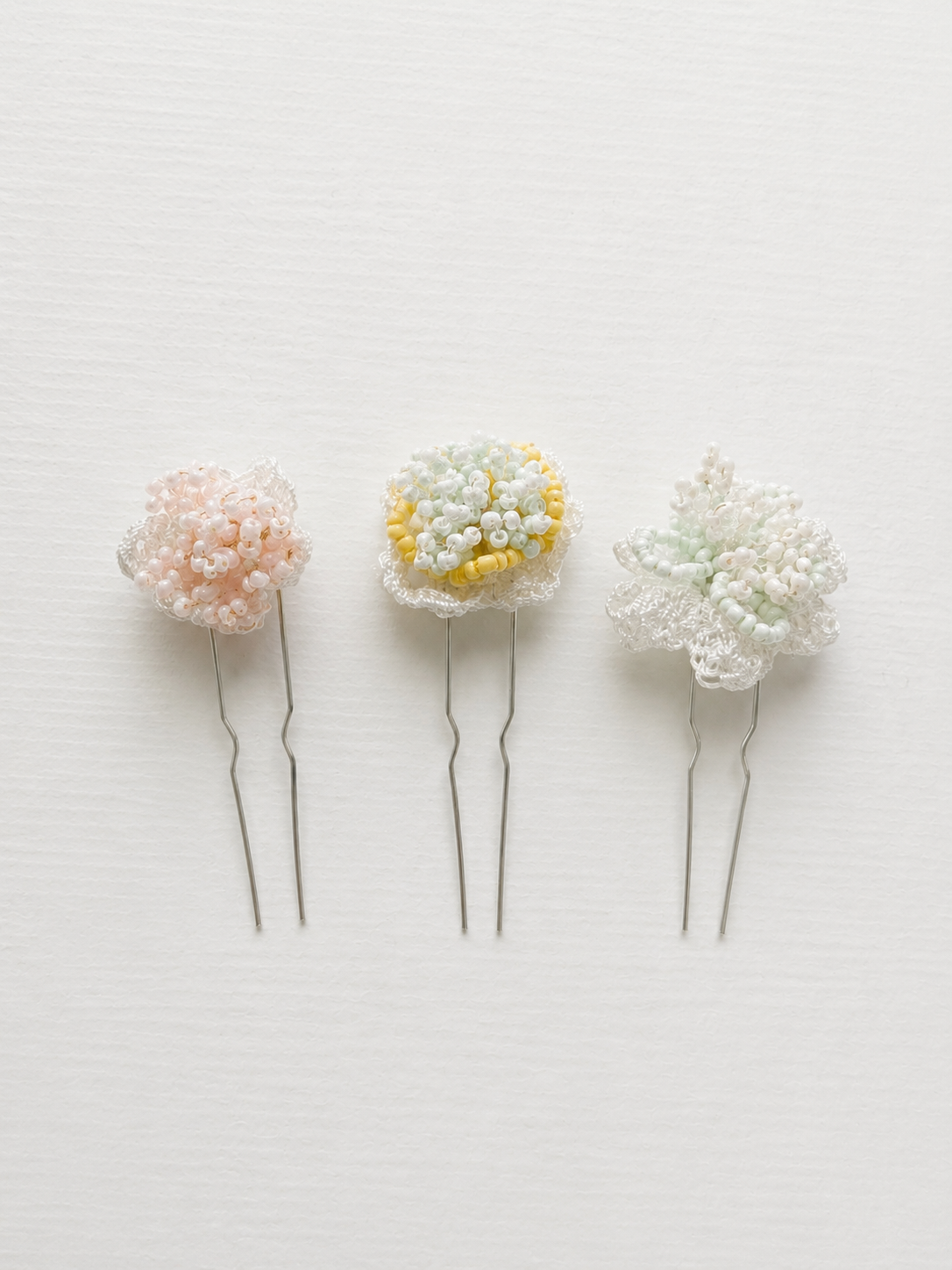 Blossom floral bridal hair pins by Vowen, three handmade lace flowers beaded in pastel tones