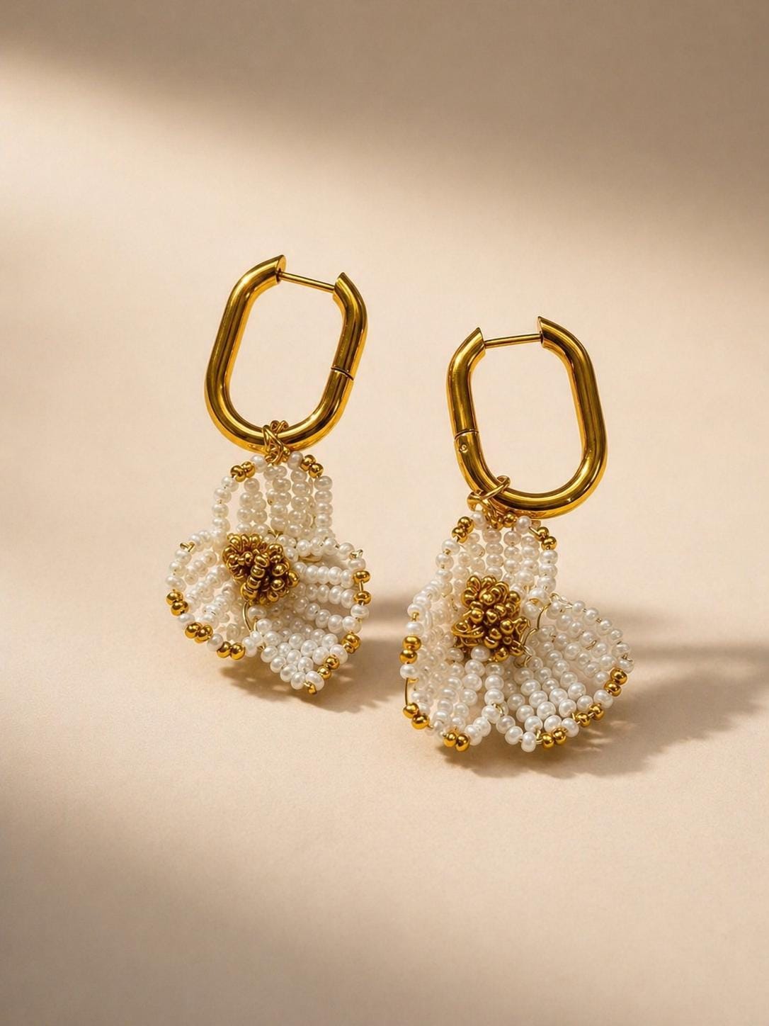 Edie bridal earrings by Vowen, hand-beaded ivory flowers on gold-tone huggie hoops