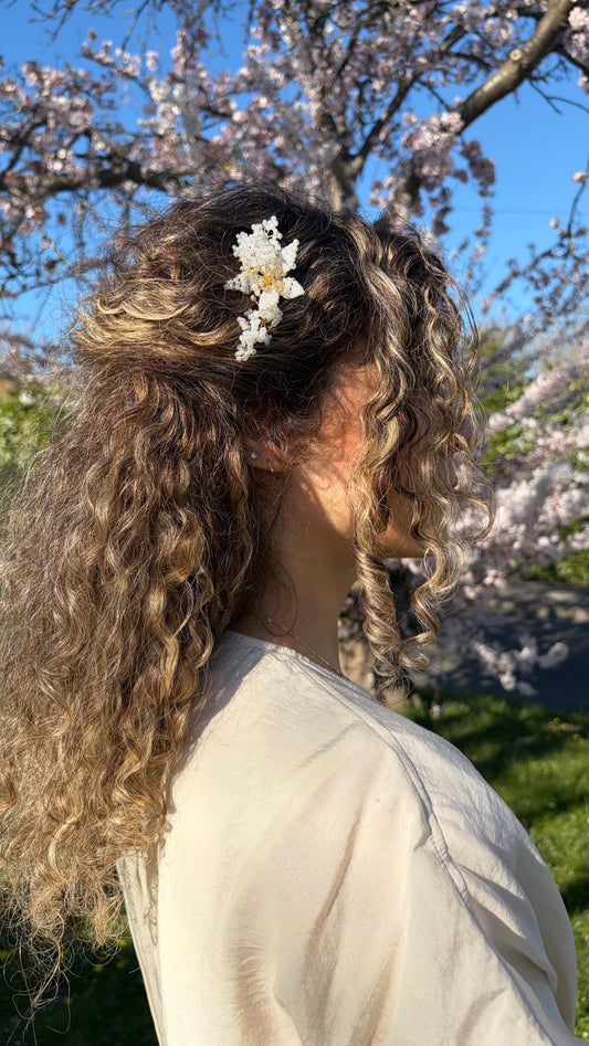 Florence hair comb worn in loose curls under a cherry blossom tree