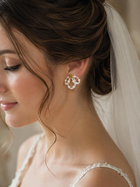 Bride wearing the Iris earrings with a soft updo and veil