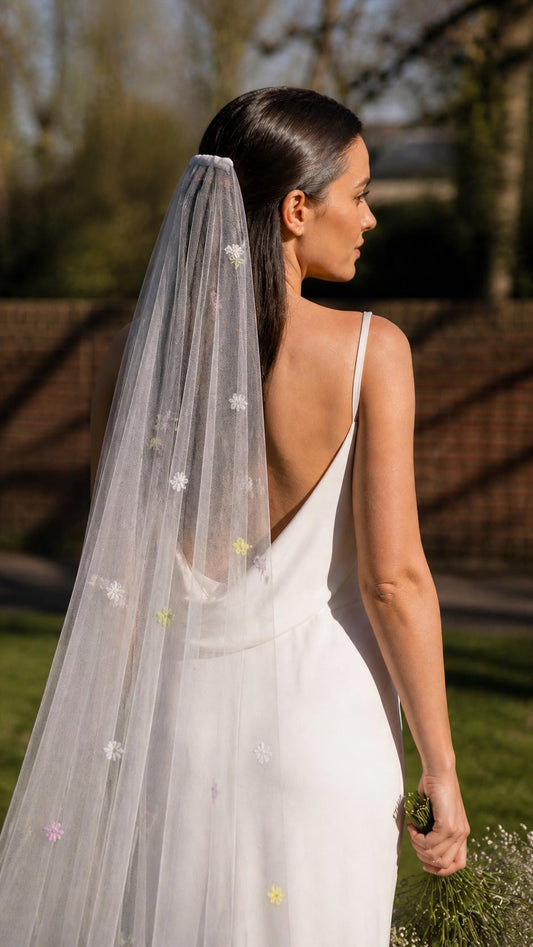 Bride in an ivory slip dress wearing the Olivia daisy-embroidered silk tulle veil