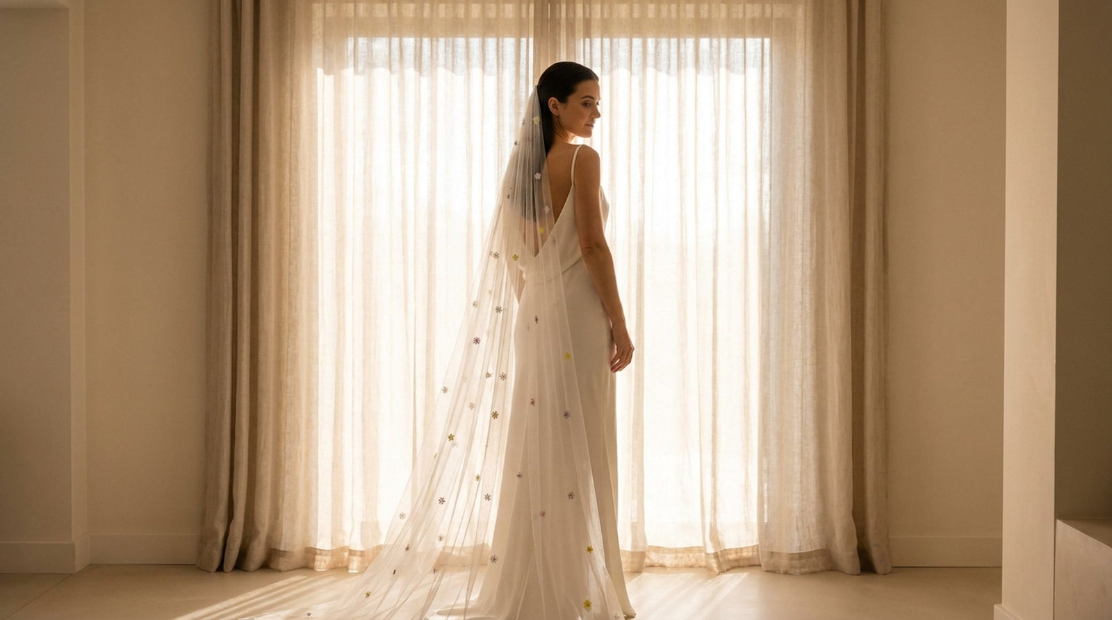 A bride wearing a Vowen hand-embroidered silk tulle bridal veil in soft daylight